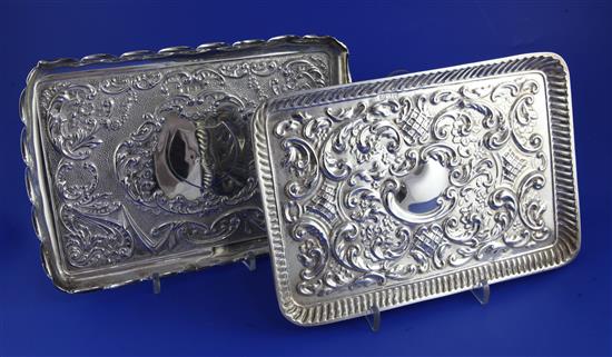 Two late 19th/early 20th century repousse silver dressing table trays, 16.5 oz.